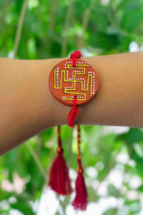 Antarang (Set Of 2) Terracotta. Swastik- Handpainted Terracotta Rakhi. Made By Divyang Rural Women