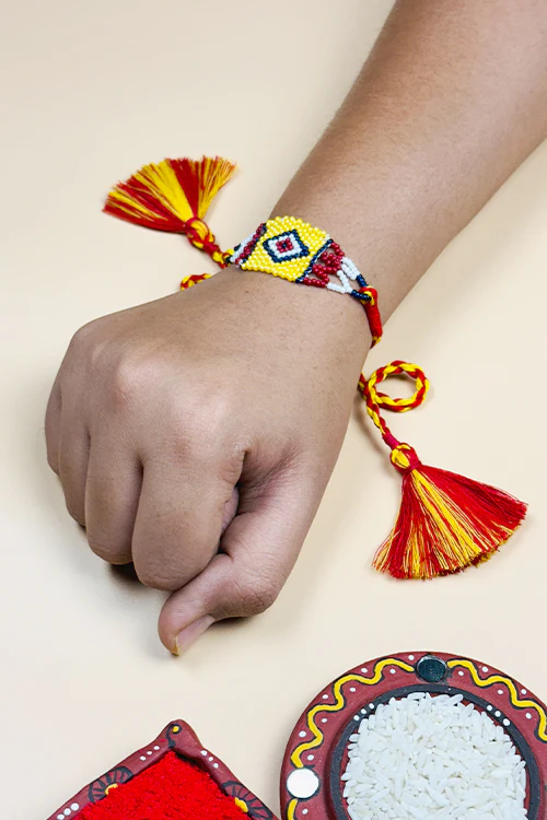 Antarang (Set Of 2) Traditional Saurastra Beadwork Rakhi, 100% Cotton, Bhai Rakhi. Yellow-Marron. Made By Divyang Rural Women