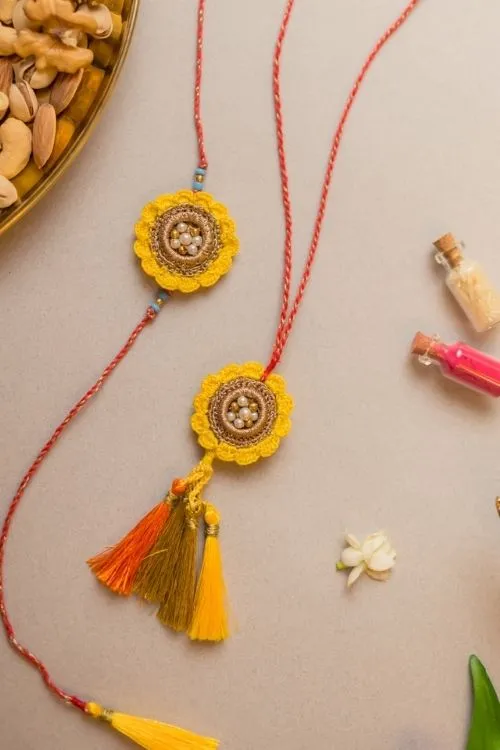 Samoolam Marigold Crochet Rakhi & Lumba Set (Set Of 2)